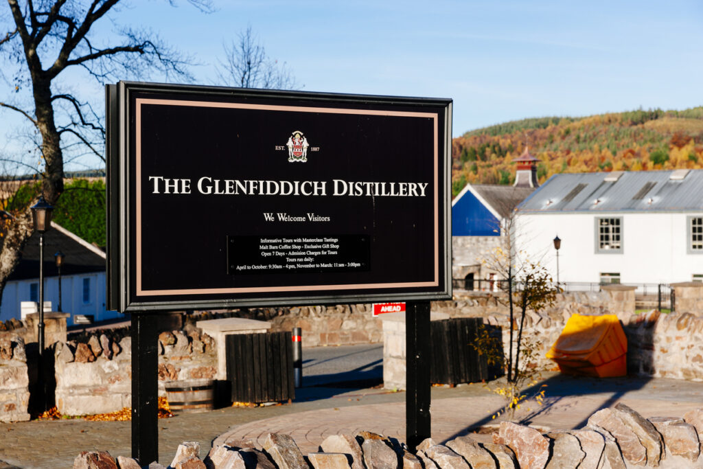 Dufftown, United Kingdom - November 01, 2015: Entrance sign to the Glenfiddich distillery and bonded warehouses at Dufftown in Scotland. Located in the heart of whisky country (the word whisky derives from the Gaelic uisge beatha, meaning 'water of life') it is a popular 'must see' tourist destination.